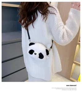 Cute plush panda crossbody bag shown on a model wearing a soft white sweater.
