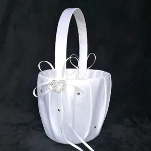 Elegant white satin flower girl basket detailed with ribbon and heart-shaped rhinestones