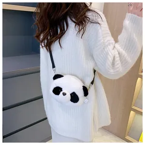 Close-up of a cute panda plush crossbody bag worn over a white knit sweater
