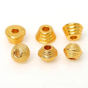 Macro view of S925 sterling silver gold plated threaded spacer beads for jewelry DIY crafts
