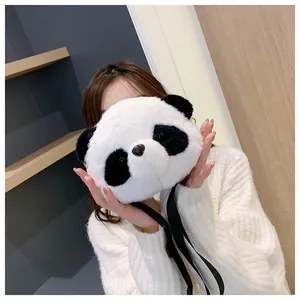 Cute panda plush crossbody bag held by a model in a stylish indoor setting
