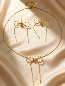 Elegant gold stainless steel jewelry set featuring bow necklace and stud earrings