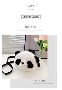 Close-up of a cute plush panda shoulder bag with soft white fur and black strap