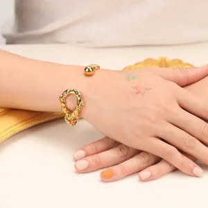 Irregular 18K gold plated open cuff bracelet with a unique knotted design