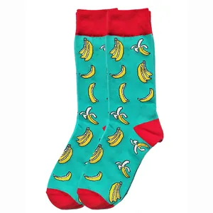 Close-up of turquoise cotton crew socks featuring a vibrant yellow banana print pattern.