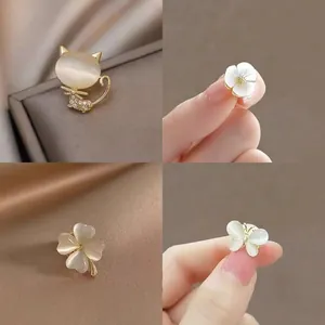 Detailed collage of elegant opal-style pins in cat, flower, clover, and butterfly shapes.