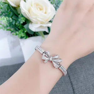 Elegant silver ribbon bow-knot bracelet with sparkling simulated diamonds for women.