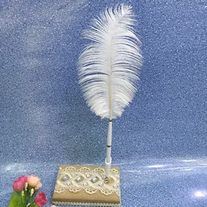 Elegant white ostrich feather wedding guest sign-in pen with rustic burlap and lace base