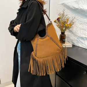 Bohemian style brown suede shoulder bag featuring retro fringe and sun embossed design