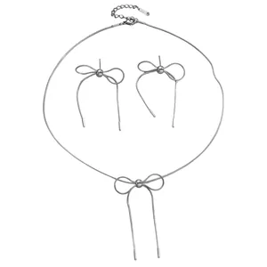 Detailed view of silver stainless steel bow necklace and earring jewelry set for women