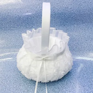 Detailed macro view of elegant white rose pattern fabric flower girl basket for weddings