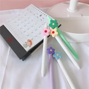 Detail view of cute white flower gel pens with 0.5mm black ink for office stationery