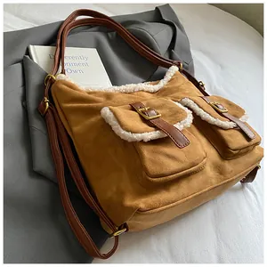 Stylish brown fleece tote bag with white shearling trim and vintage buckle details.