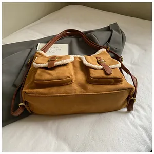 Winter brown suede tote bag with sherpa trim and front pockets, lifestyle detail view