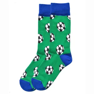 Close-up of green cotton crew socks featuring a classic black and white football pattern.