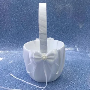 Detail view of white satin wedding flower girl basket with pearl bow