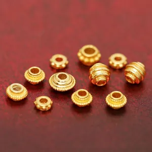 Detailed macro view of antique style gold-plated silver spacer beads for DIY jewelry
