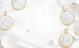 Detail of gold-plated pendants with white mother-of-pearl and lab opal accents