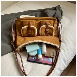 Large brown suede tote bag with fuzzy white trim showing spacious interior storage