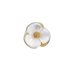 Elegant white shell flower brooch pin for women with textured gold-toned center