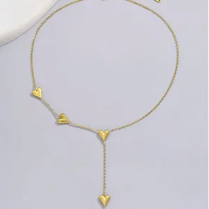 Elegant gold stainless steel necklace featuring a Y-shaped drop with four small hearts.