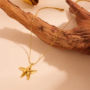 Detailed view of a gold-plated hollow starfish pendant on a beaded snake chain necklace