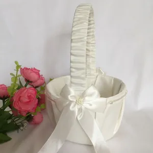 Elegant white satin wedding flower girl basket with bow and pearl detail for ceremony