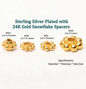 Detailed view of four S925 sterling silver 24K gold plated snowflake spacers in varied sizes