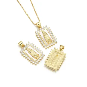 Gold-plated Virgin Mary pendant with mother of pearl and zircon stones on white background
