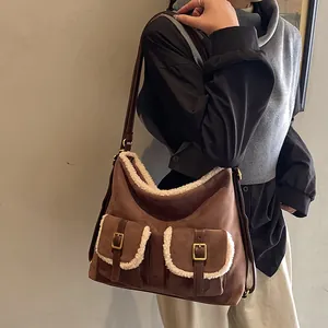 Fashionable brown suede tote bag featuring white fleece trim and dual buckle pockets