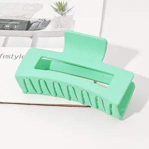 Close-up detail of a large mint green matte rectangular hair claw clip for thick hair