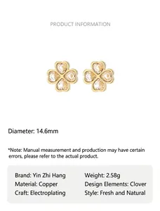 Close-up of four-leaf clover earrings featuring sparkling crystals and gold-plated finish
