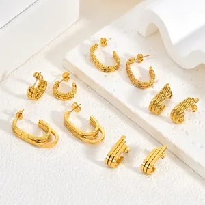 Collection of vintage gold plated stainless steel geometric earrings on white background