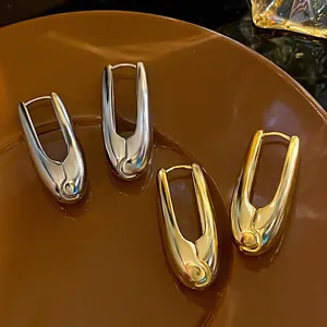 Close-up of polished water drop shaped earrings in gold and silver finishes