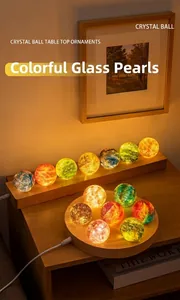 Detail shot showing vibrant glowing starry night crystal balls on a wooden LED base
