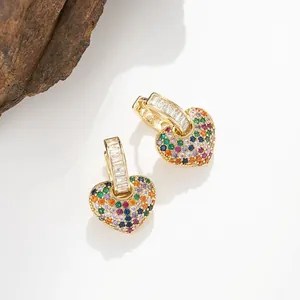 Macro detail of heart-shaped drop earrings featuring colorful pavé zircon crystals