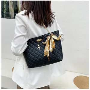 Elegant black quilted chain shoulder bag featuring a silk scarf bow and deer charm