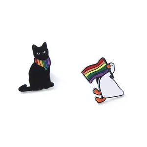 Detailed view of cute enamel pins featuring a black cat and a white duck with rainbow flags