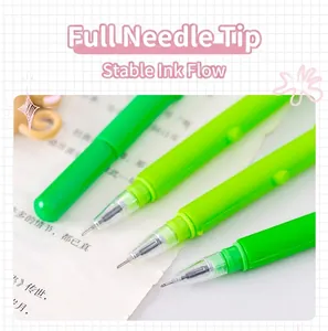 Close-up view of the fine needle point tip on a vibrant green cartoon gel pen.