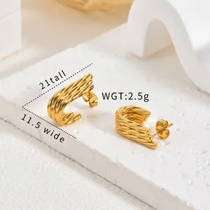 Detailed macro view of vintage gold twisted hoop earrings with size and weight specs