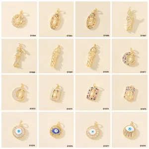 Collezione di 16 pendenti placcati oro con zirconi e motivi religiosi