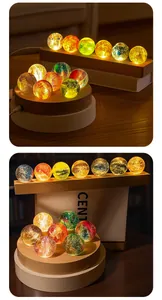 Beautiful detailed view of colorful starry glass ball night lights on warm wooden bases