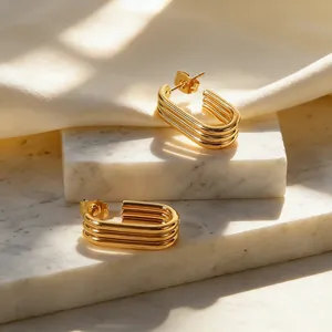 Detailed view of three-layer gold U-shaped stainless steel geometric hoop earrings