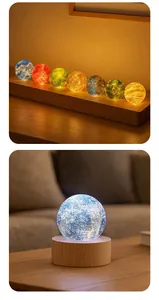 Detailed view of colorful glowing starry sky crystal balls on wooden bases.