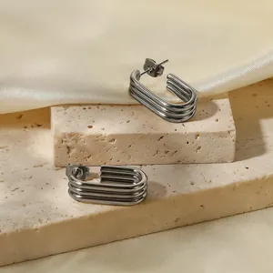 Macro view of three-layer stainless steel U-shaped earrings with minimalist design