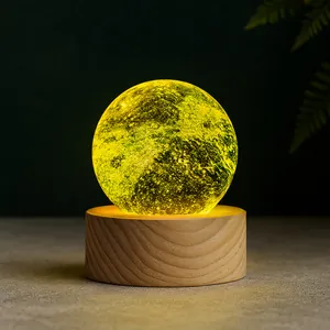 Detailed view of a glowing planet crystal ball lamp on a natural wooden base stand