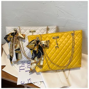 Quilted chain shoulder bags in yellow and white with silk scarf bow details