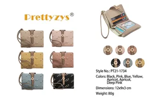 Multi-color floral print women's short bifold wallet with buckle and wrist strap detail.