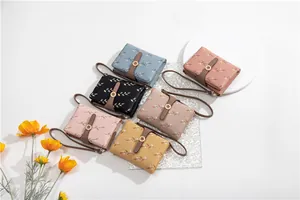 Six colorful floral print women's short bi-fold wallets with elegant wrist straps