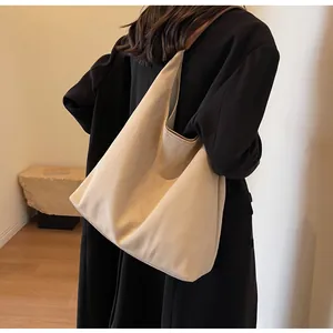 Detailed view of a large beige suede tote bag for women's daily fashion commute.
